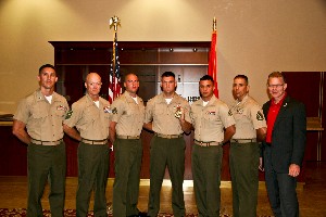 Witzel (r) congratulates the graduates of the radio supervisor course, who stood with their instructors: (l-r) Capt. Jeffrey Bauer, USMC, officer in charge, CTC-1; Master Gunnery Sgt. William Warren, USMC, communications chief, First Marine Division; Cpl. Christopher Ingram, USMC, first runner-up; Sgt. Casey Stacks, USMC, honor graduate; Cpl. Jonathan Ingersoll, second runner-up; and Staff Sgt. Keith Cabrera, USMC, chief instructor, radio supervisor course, CTC-1. 